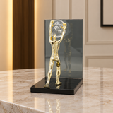 Man Holding Crystal Ball Sculpture at Zubaidas Homestore